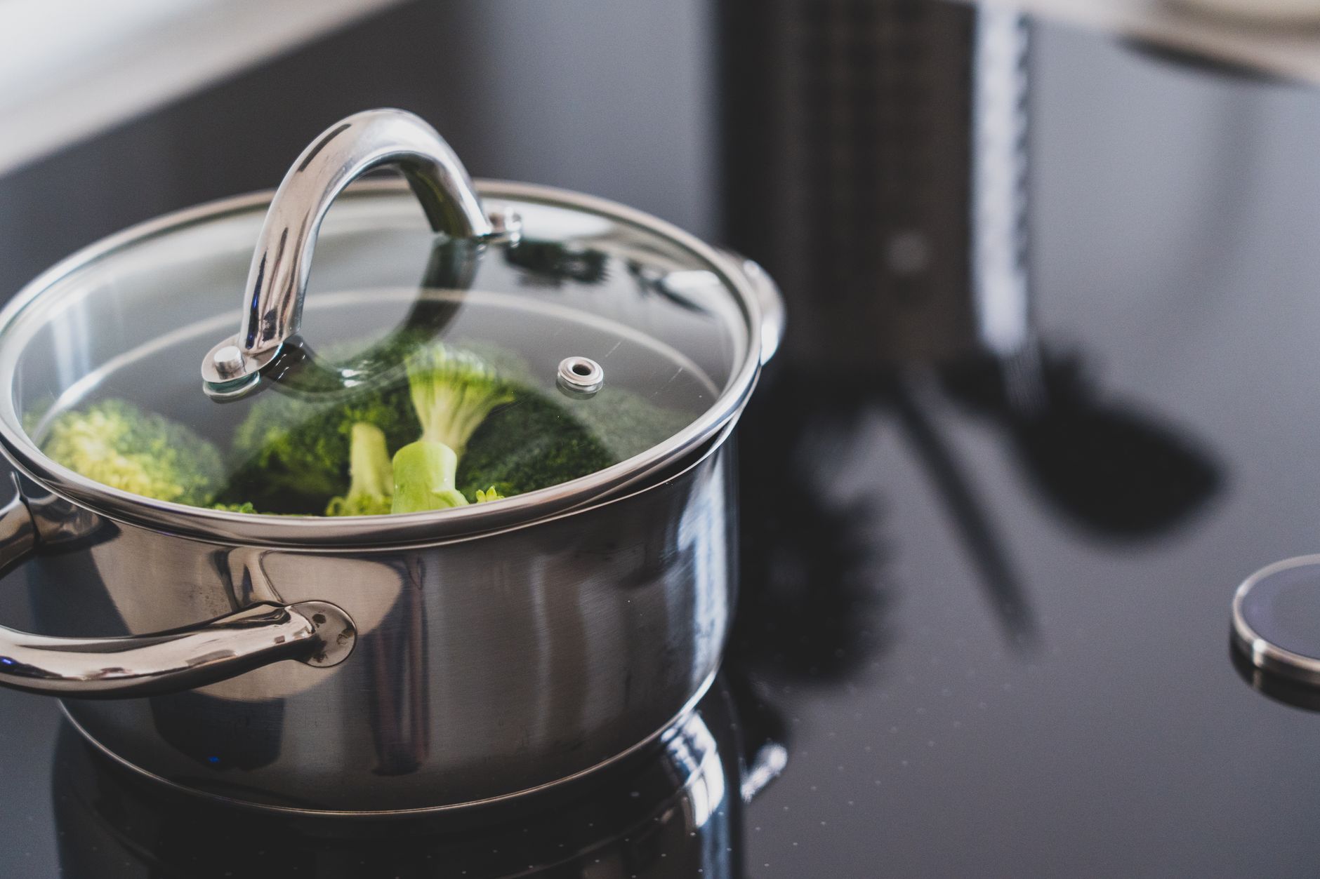 GreenPan ceramic nonstick pots and pans arranged on a kitchen counter