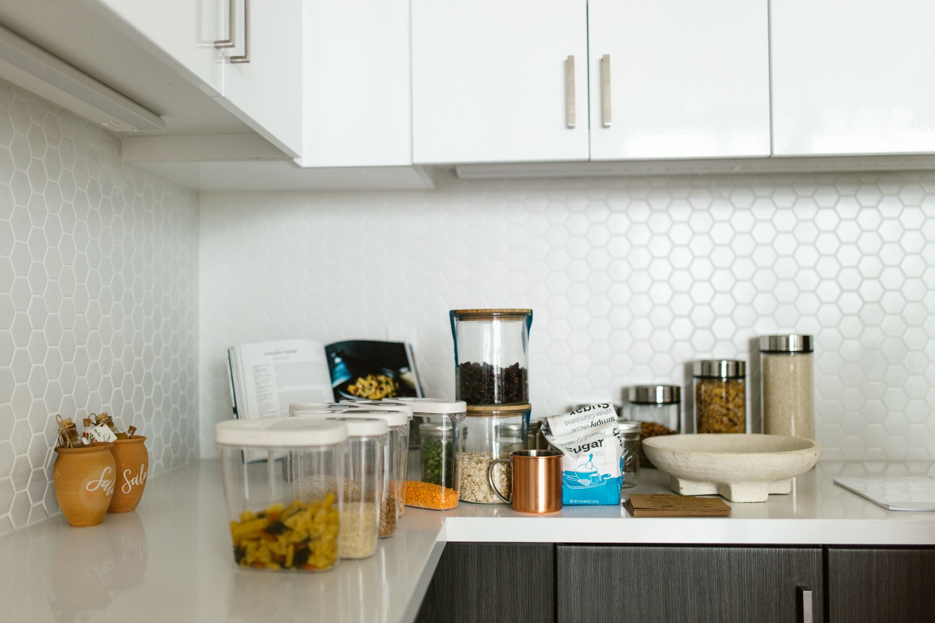Clear glass food storage containers with plastic lids on a kitchen counter