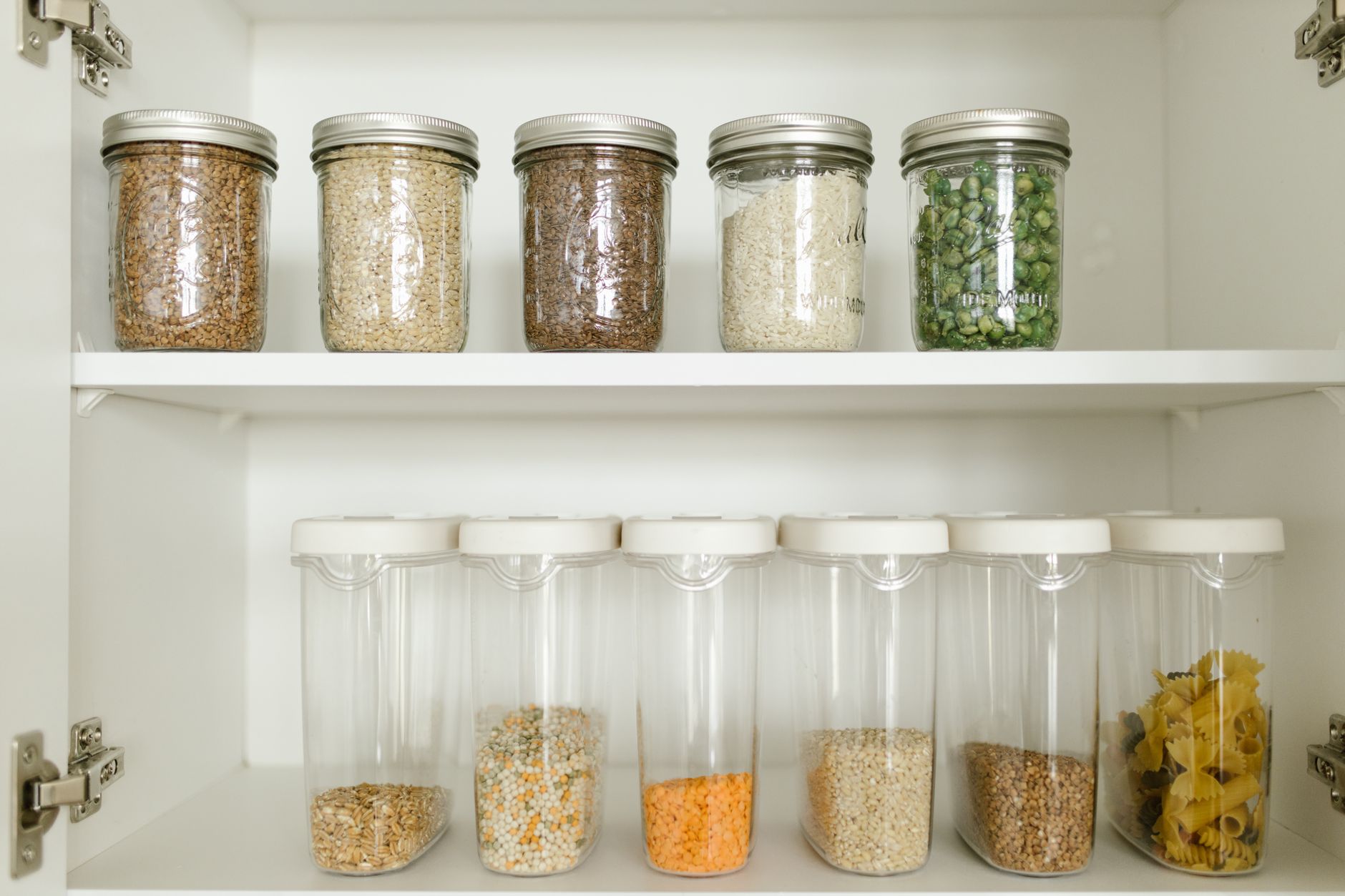 glass food storage containers with lids arranged on a kitchen shelf