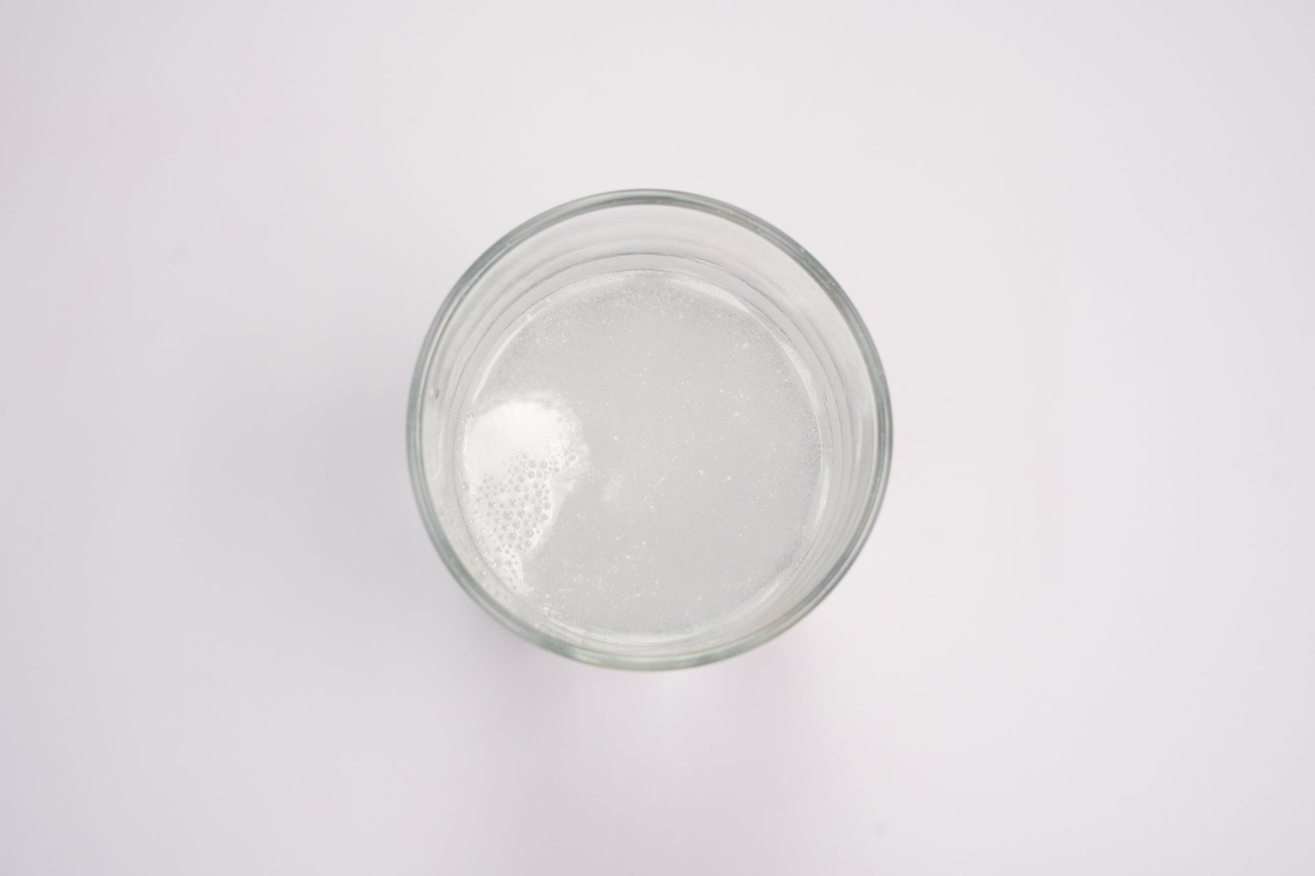 a cleaning tablet dissolving in a glass spray bottle filled with water