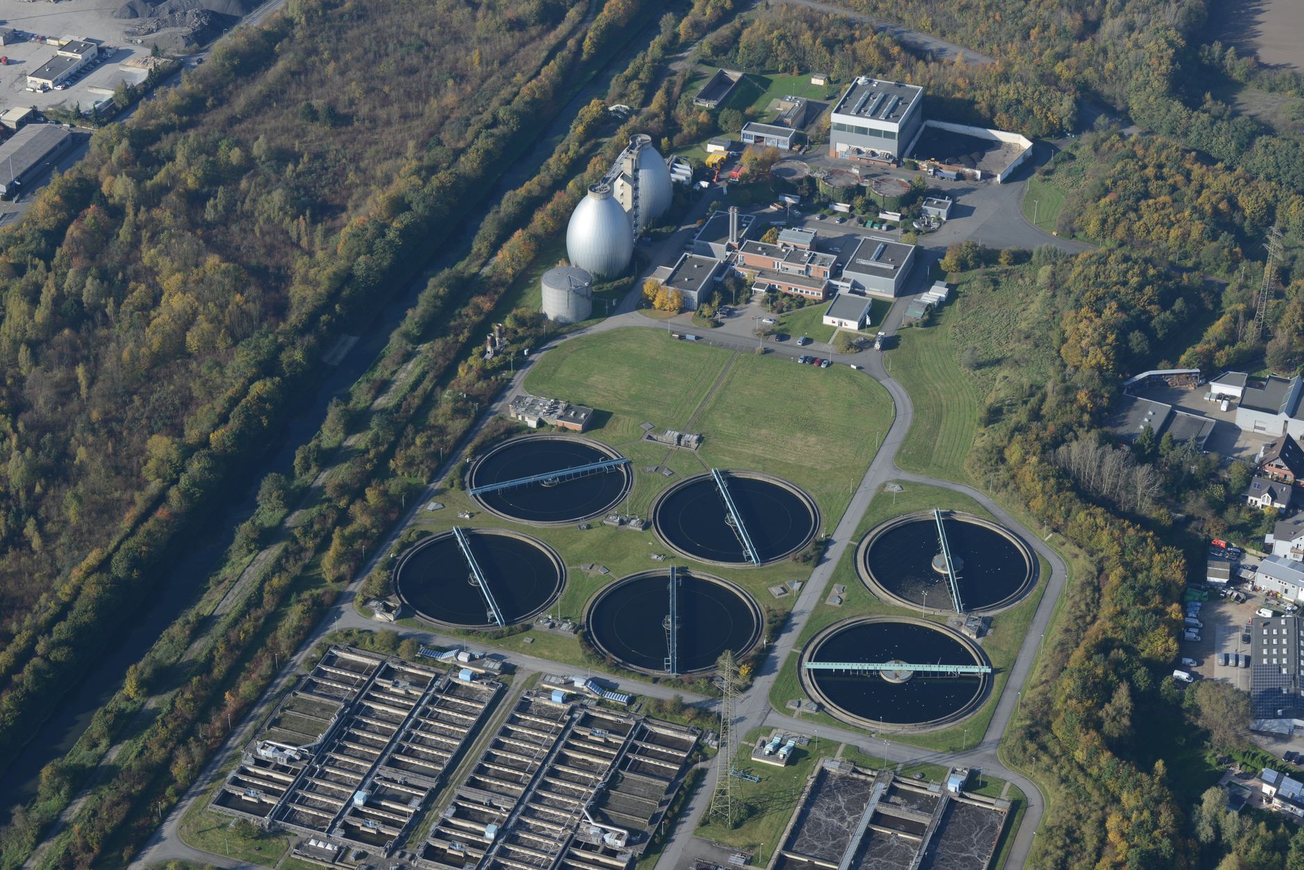 an aerial view of a water treatment plant beside a river